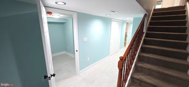 a bed room with a bed and a painting on the wall