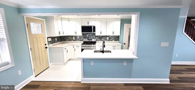 a kitchen with a refrigerator and a sink
