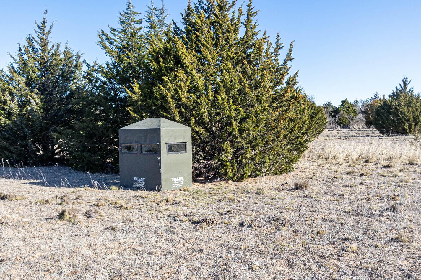 6643 Co Rd 7 Shamrock, TX 79079 - Photo 20 of 55 a wooden fence with trees in the background