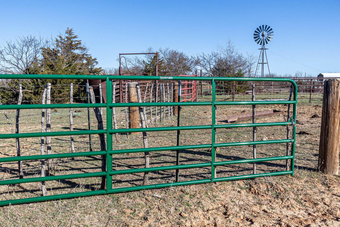 6643 Co Rd 7 Shamrock, TX 79079 - Photo 26 of 55 a view of a brick house with a small yard and wooden fence