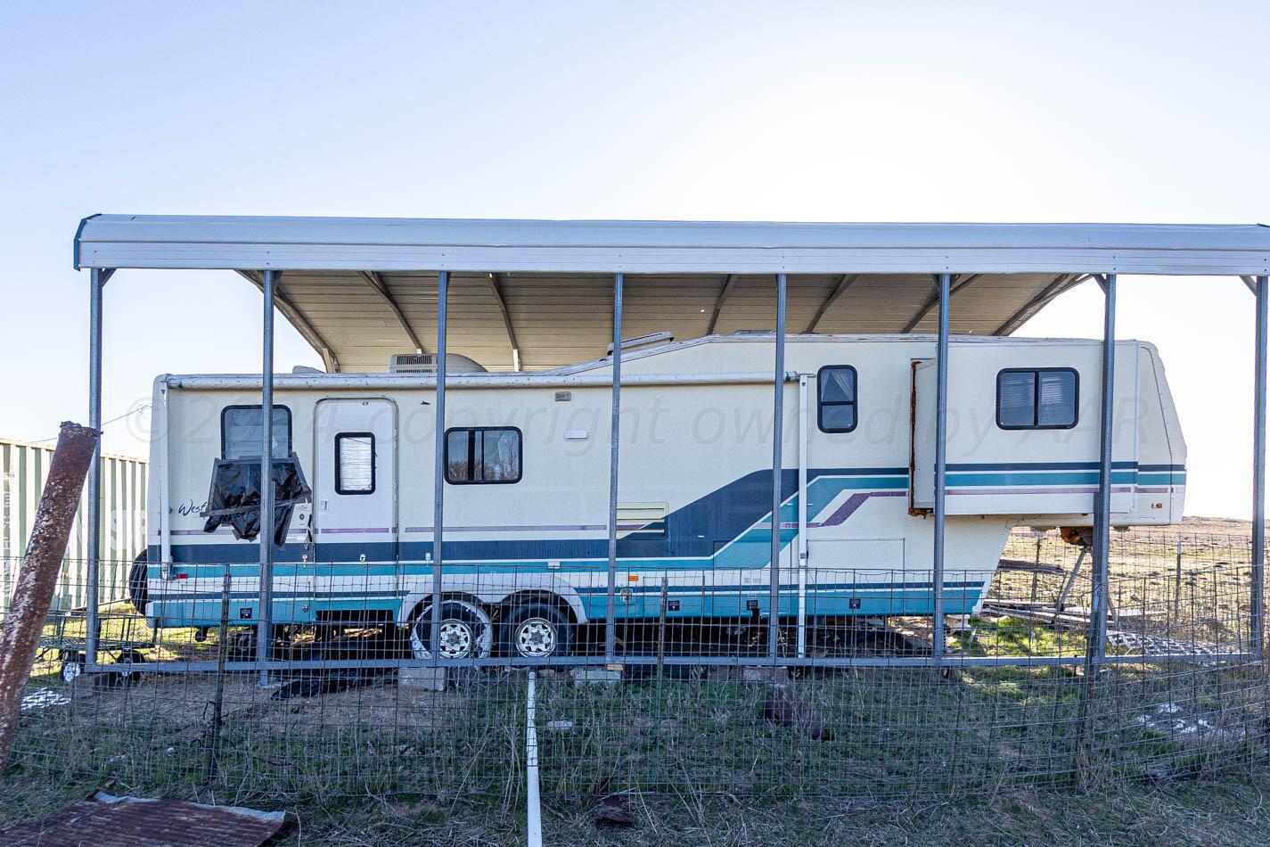 6643 Co Rd 7 Shamrock, TX 79079 - Photo 54 of 55 a table and chairs in front of a building