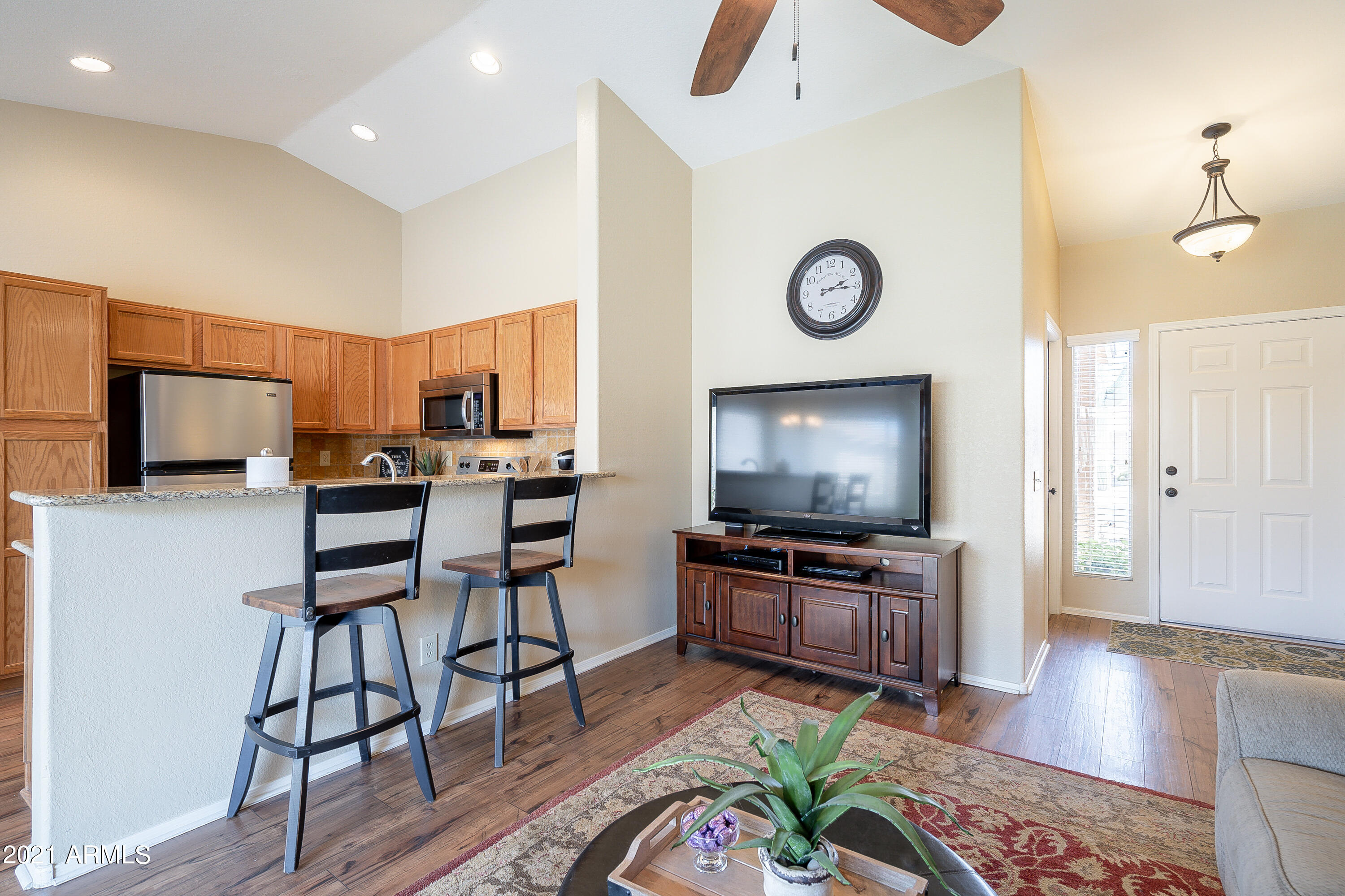 1802 East Peach Tree Drive Chandler, AZ 85249 - Photo 8 of 30 a living room with furniture a flat screen tv and kitchen view