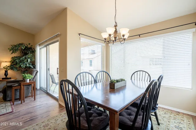 a view of a a dining room with furniture window and wooden floor