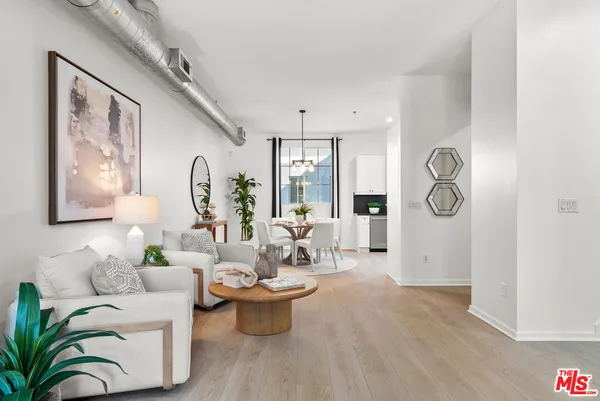 a living room with furniture a chandelier and a window