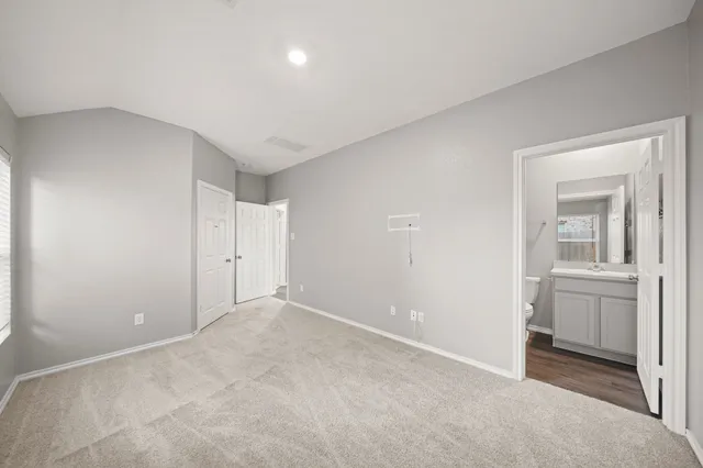 a view of an empty room and closet area