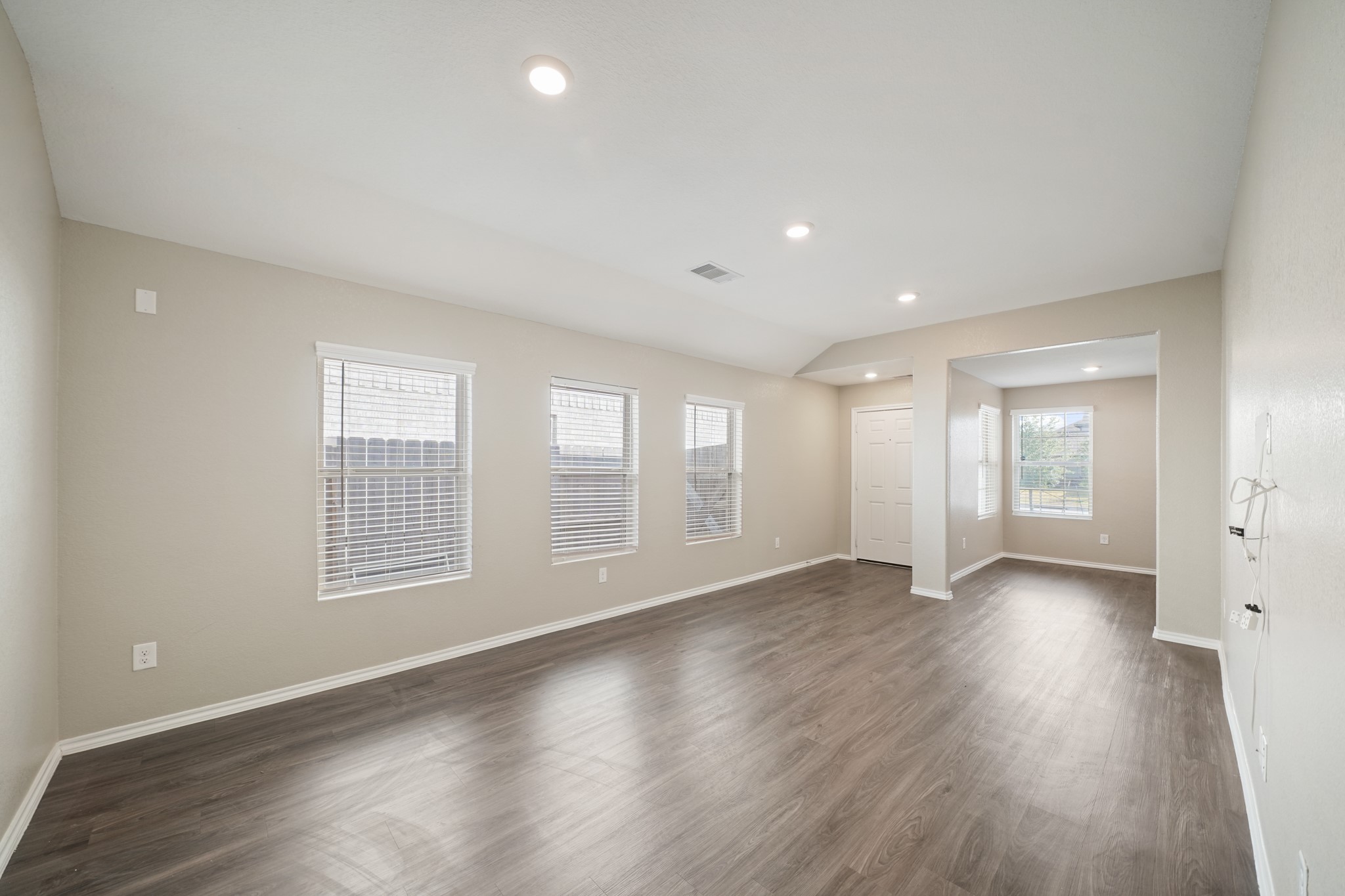 7823 Winward Ridge Way Katy, TX 77493 - Photo 18 of 25 an empty room with wooden floor and windows