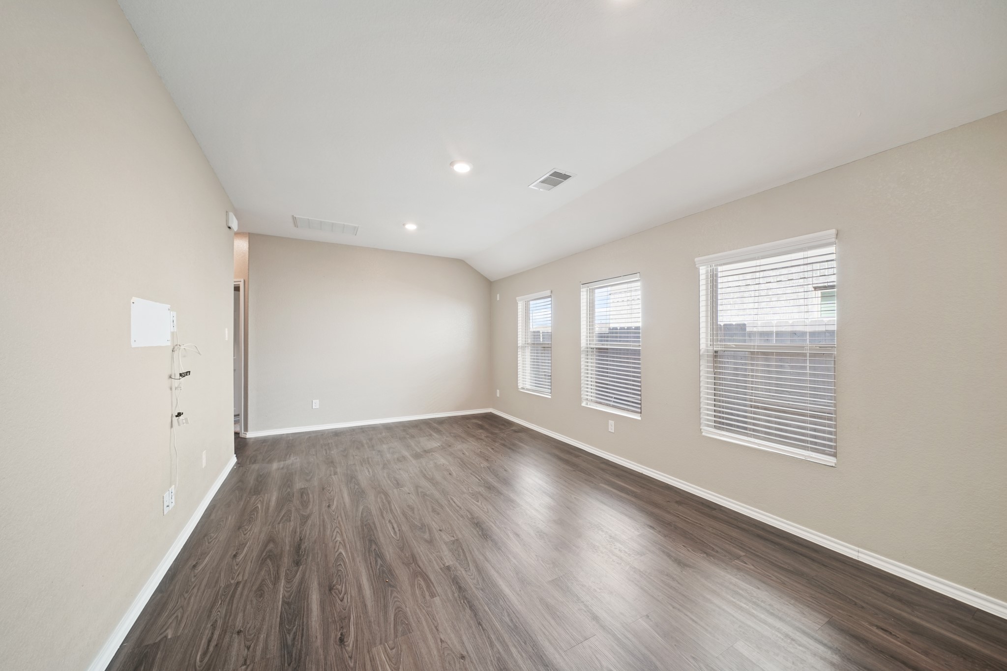 7823 Winward Ridge Way Katy, TX 77493 - Photo 19 of 25 an empty room with wooden floor and windows