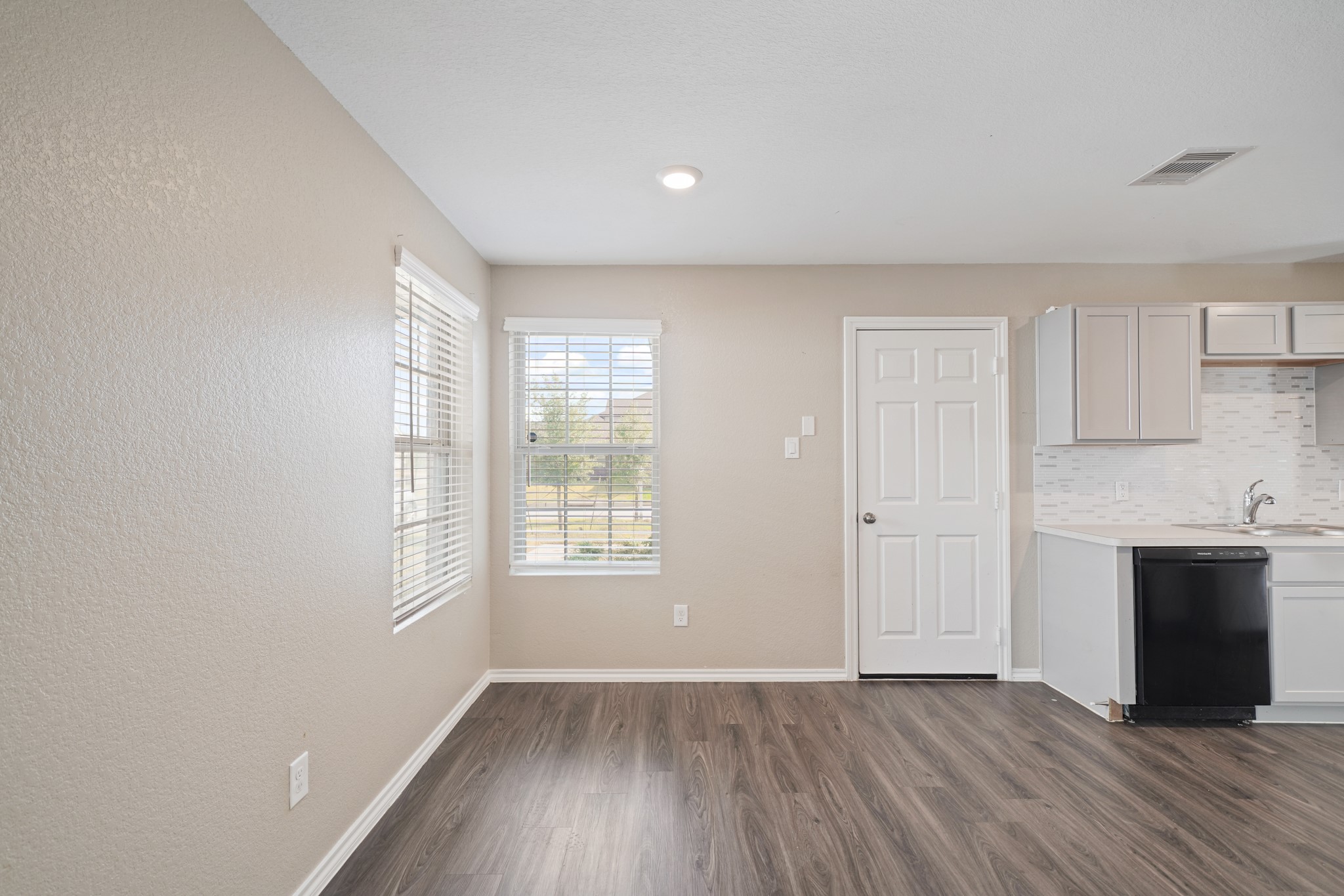 7823 Winward Ridge Way Katy, TX 77493 - Photo 20 of 25 an empty room with wooden floor and windows