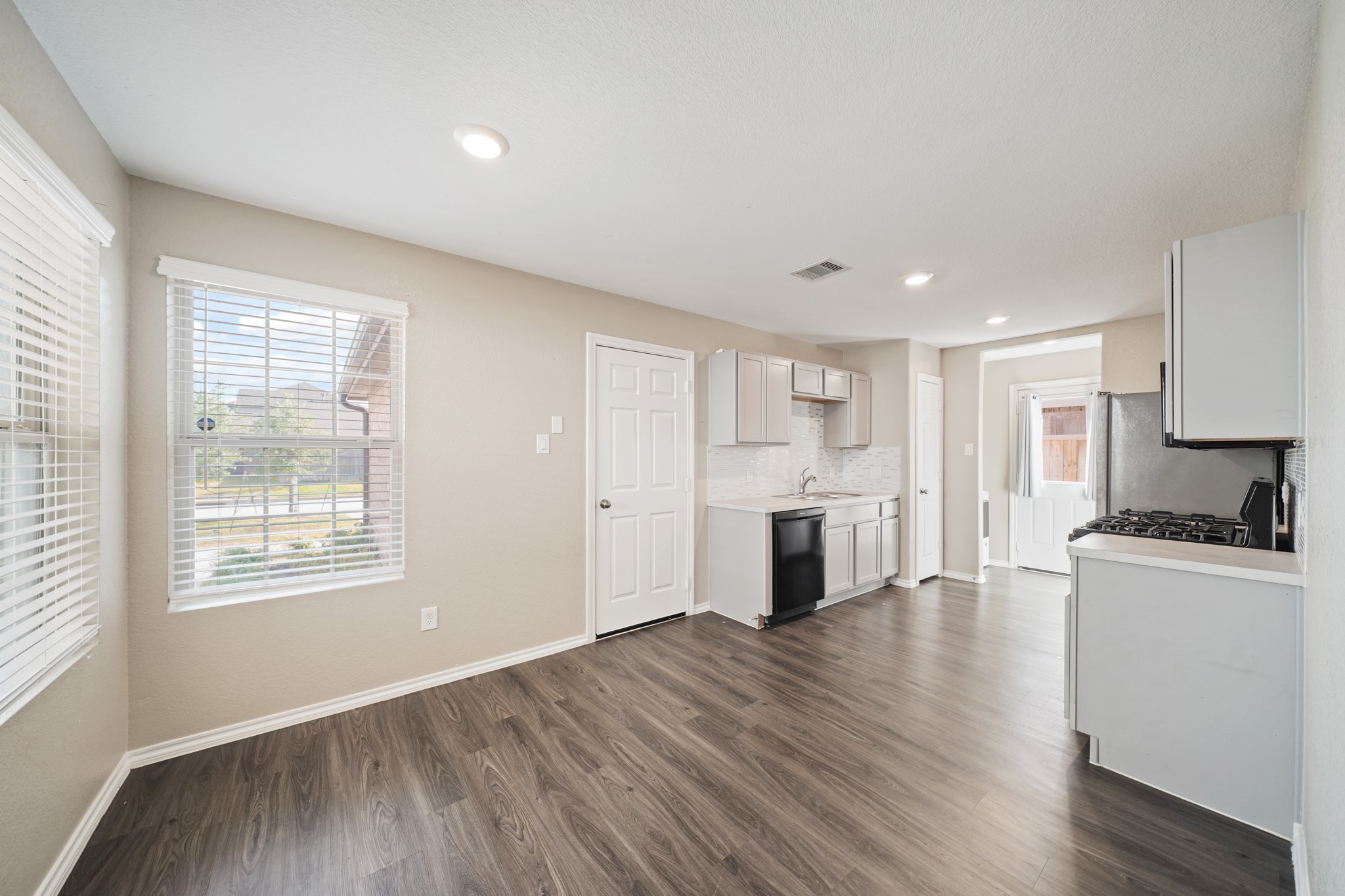 7823 Winward Ridge Way Katy, TX 77493 - Photo 21 of 25 a view of a kitchen with a stove cabinets and wooden floor