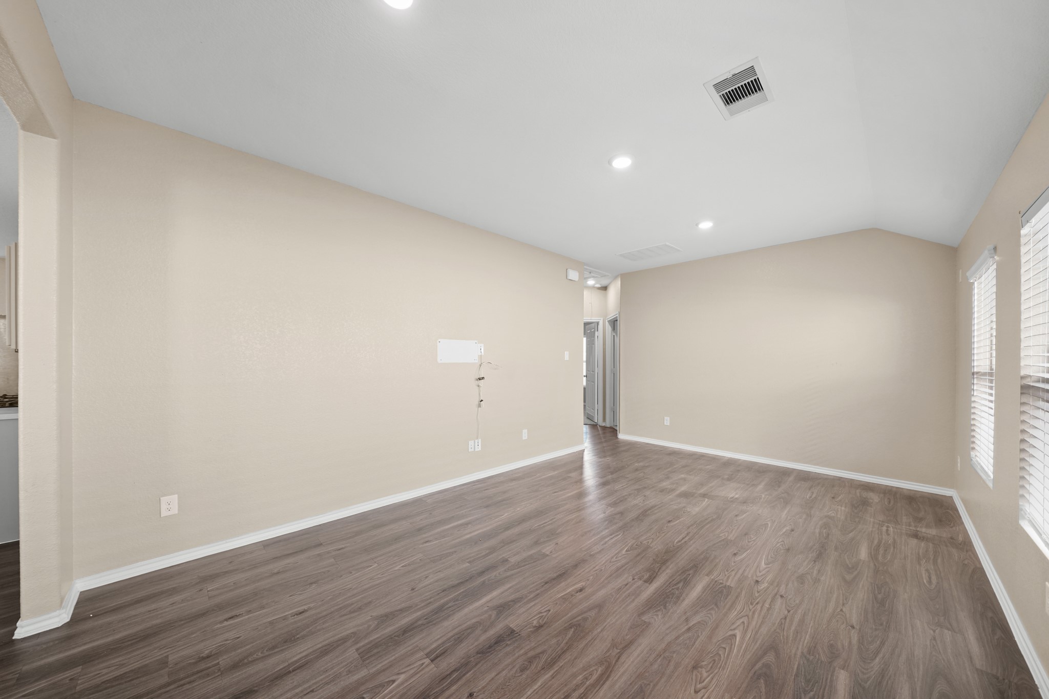 7823 Winward Ridge Way Katy, TX 77493 - Photo 7 of 25 an empty room with wooden floor and windows