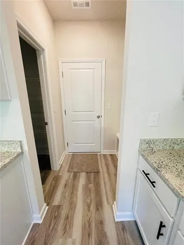 a view of walk in closet with wooden floor