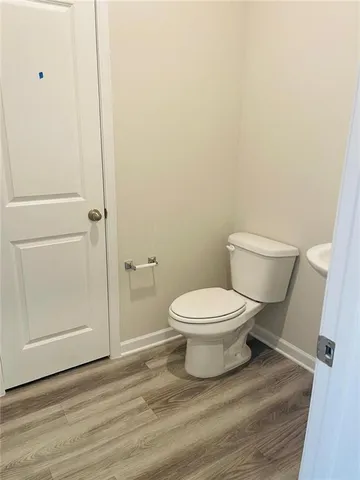 a white toilet sitting next to a bathroom sink