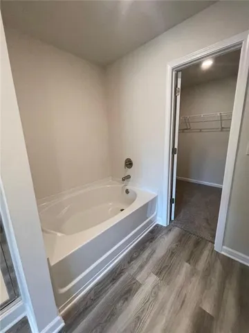 a spacious bathroom with a bathtub and shower
