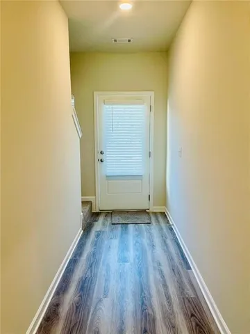 an empty room with wooden floor and doors