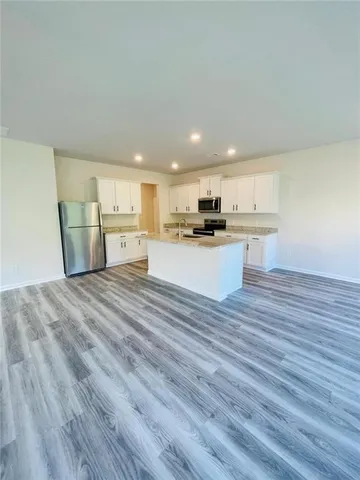 a view of kitchen and wooden floor