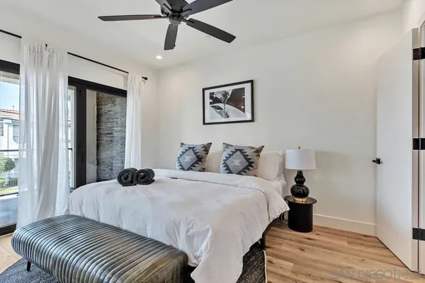 a bedroom with a bed and a large window