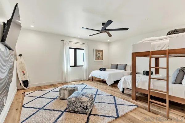 a living room with furniture a rug and white walls