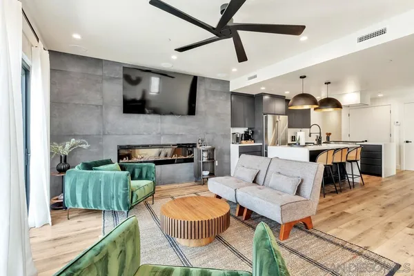 a living room with furniture and a wooden floor