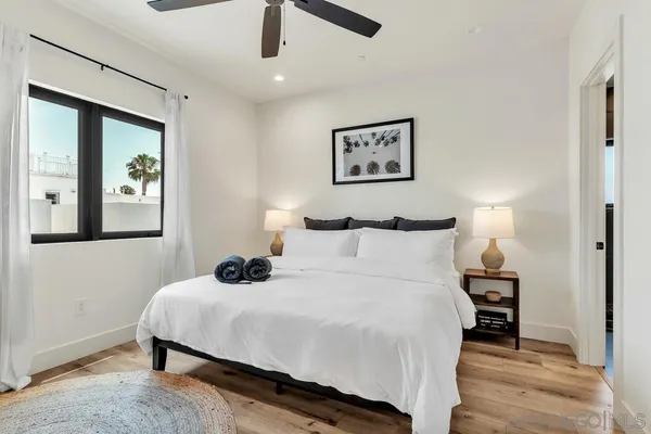 a bedroom with bed and a window