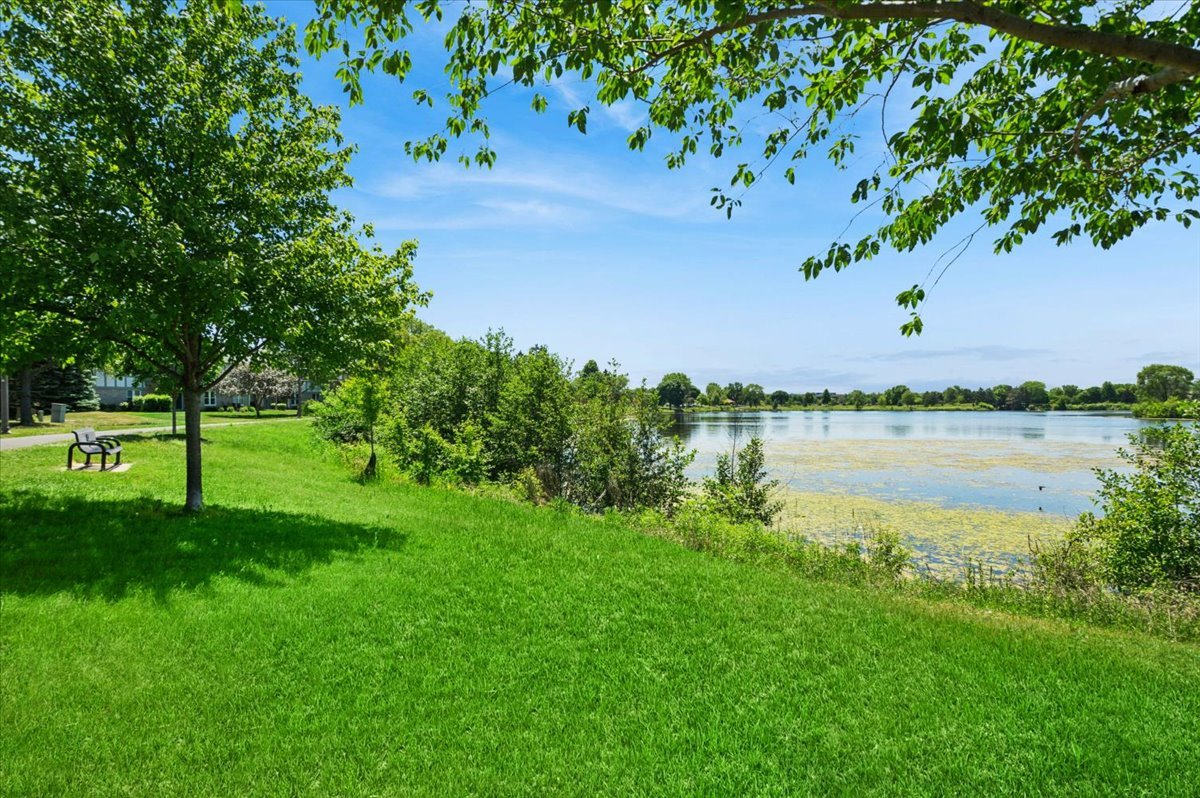 166 Hemingway Court, Unit 252 Vernon Hills, IL 60061 - Photo 16 of 18 a view of a lake with a yard