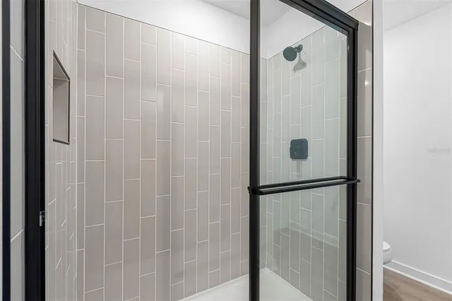 a bathroom with a glass shower door