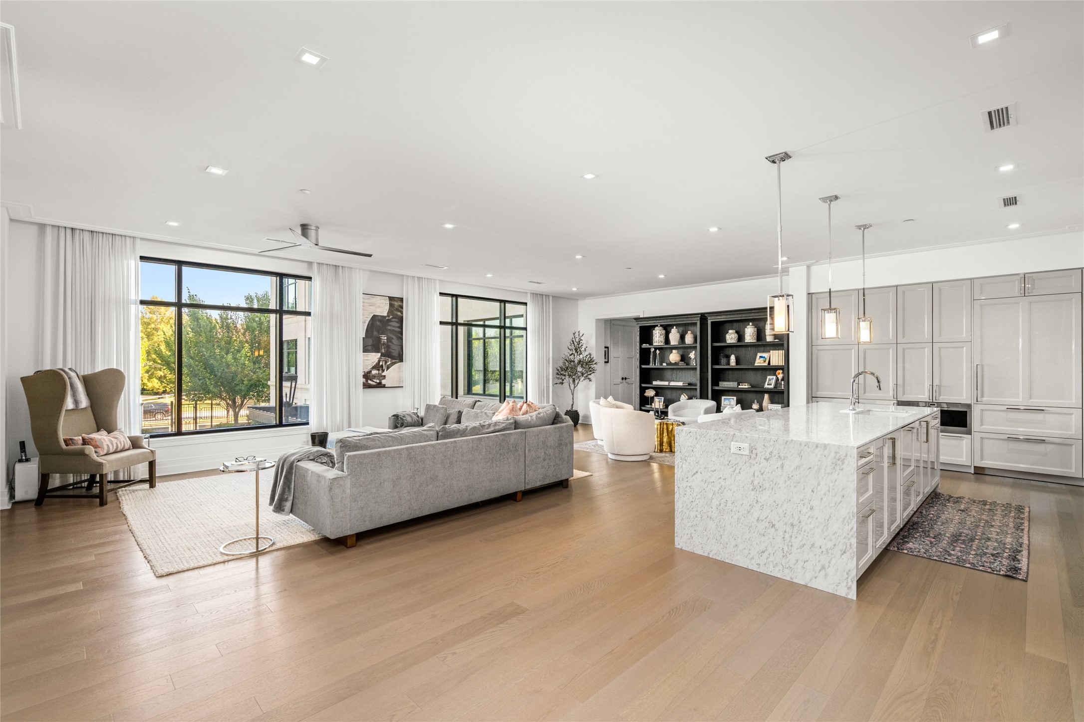 Characterized by floor to ceiling windows, Listone Giordano wood floors, and marble countertops, you will find the heart of the home - The kitchen and living room.