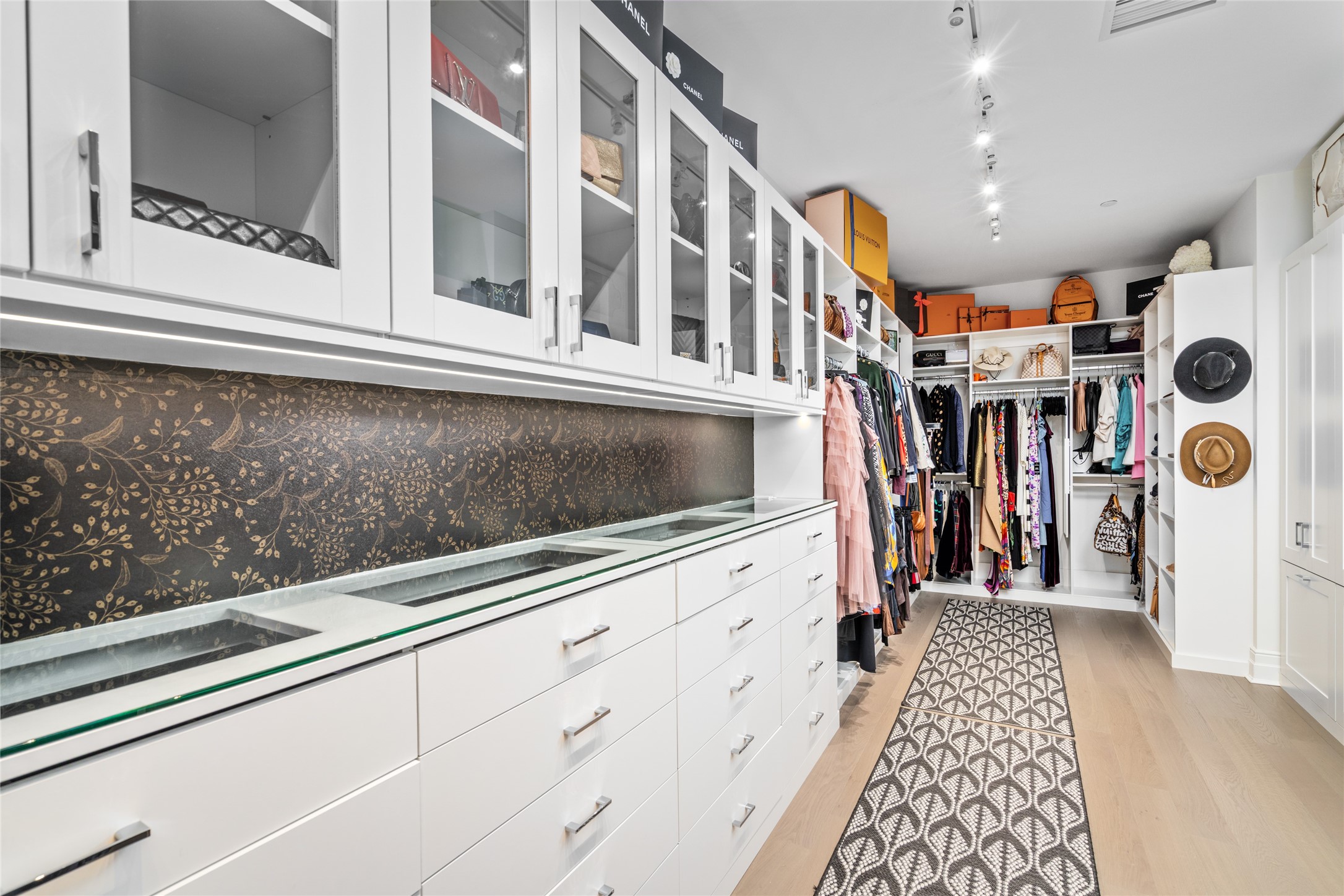 6017 Memorial Drive, Unit 202 Houston, TX 77007 - Photo 17 of 36 The closet which is outfitted by Space Manager features glass front cabinets, glass top display cases with jewelry compartments, built in shelves and drawers, and an unbelievable amount of hanging space.