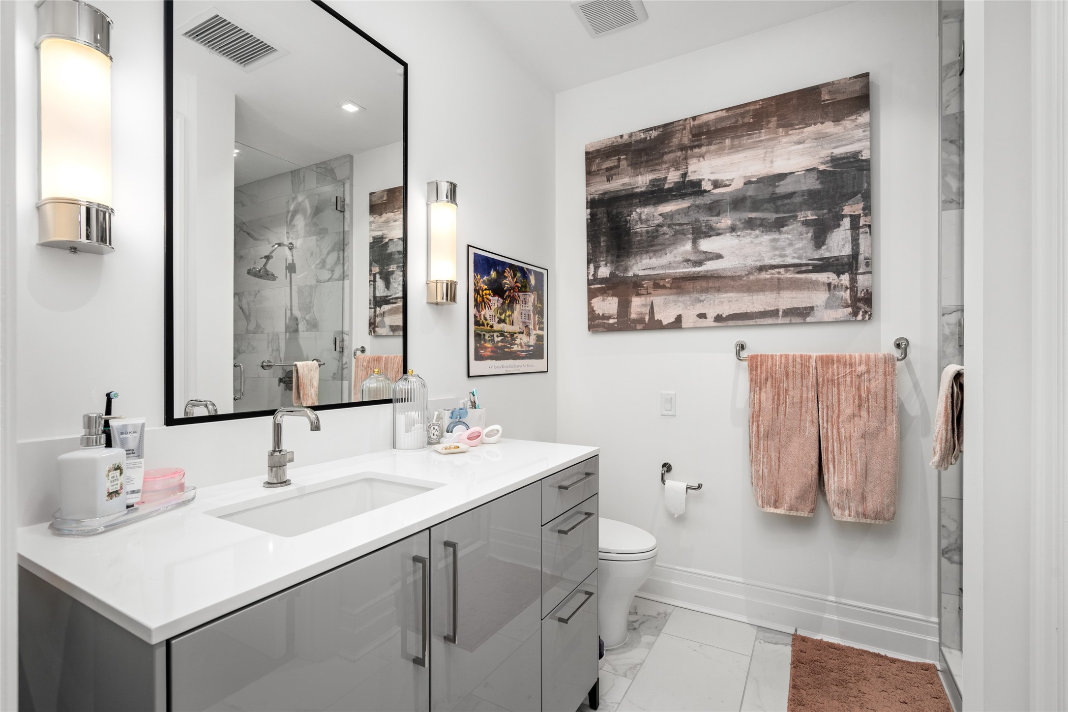 6017 Memorial Drive, Unit 202 Houston, TX 77007 - Photo 22 of 36 Exquisite, lasting finishes throughout, this bathroom features quartz counter, gray lacquer Siematic cabinetry, accent sconces, and chrome fixtures.