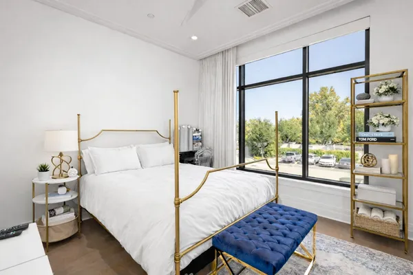 a bedroom with a bed and large window with outer view