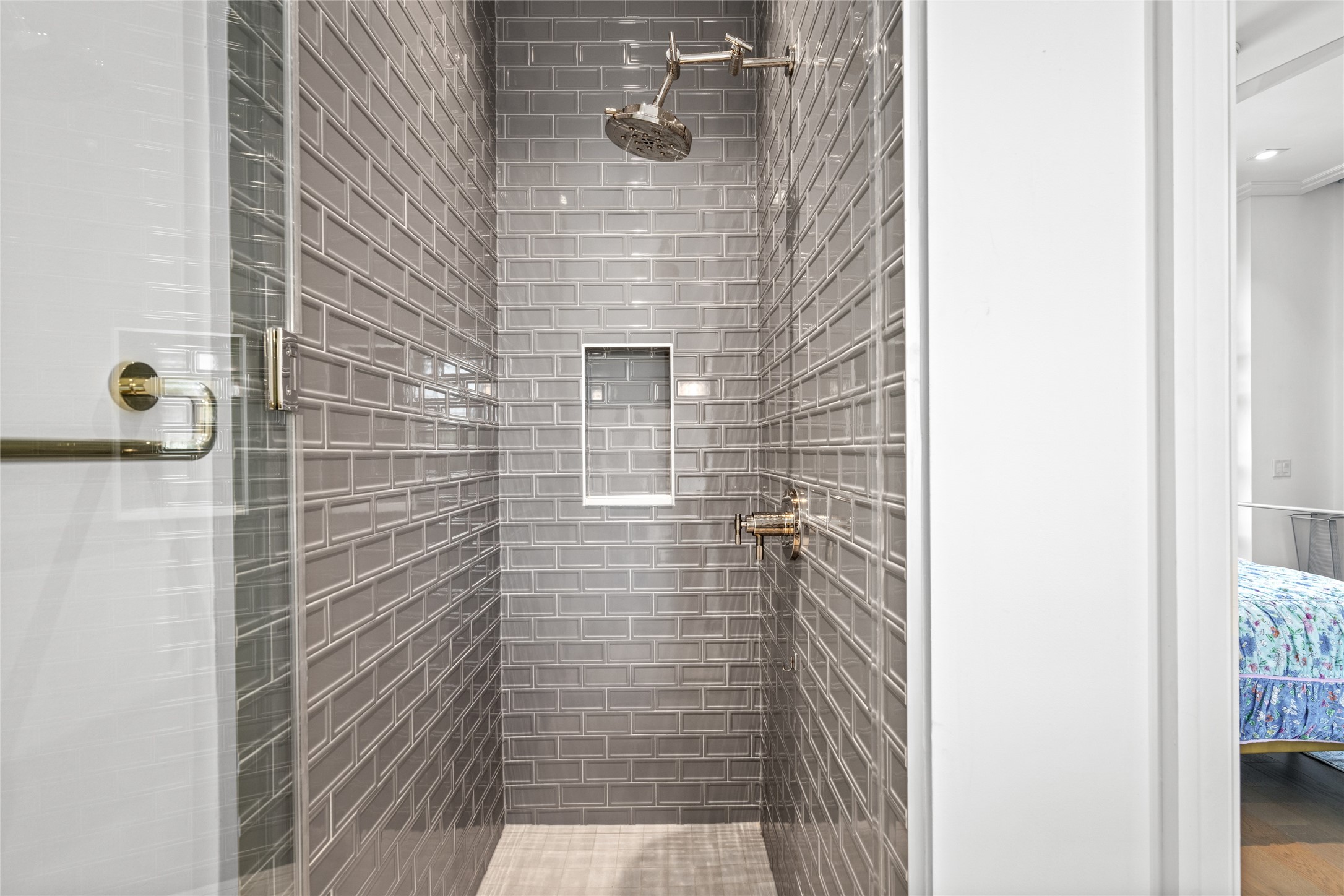 6017 Memorial Drive, Unit 202 Houston, TX 77007 - Photo 27 of 36 Step into a stylish stand-up shower, finished with charcoal gray subway tiles and chrome fixtures.