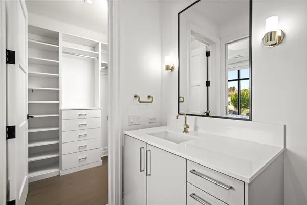 a bathroom with a sink vanity and a mirror