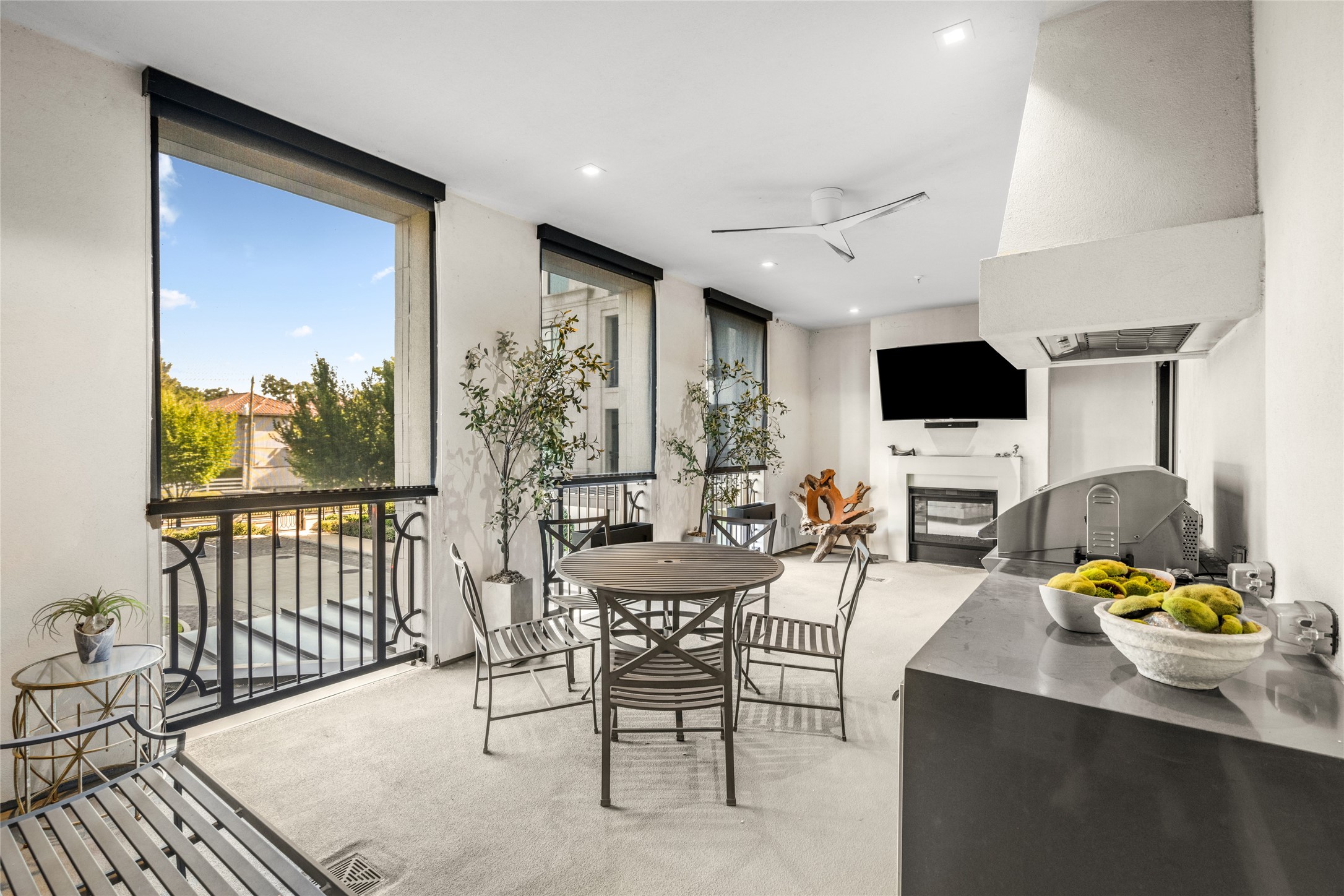 6017 Memorial Drive, Unit 202 Houston, TX 77007 - Photo 29 of 36 The main terrace has everything you could ask for – Ample space for entertainment, a two-sided gas log fireplace, privacy solar shades, mounted TV, and a built in pet pad with a water spicket.