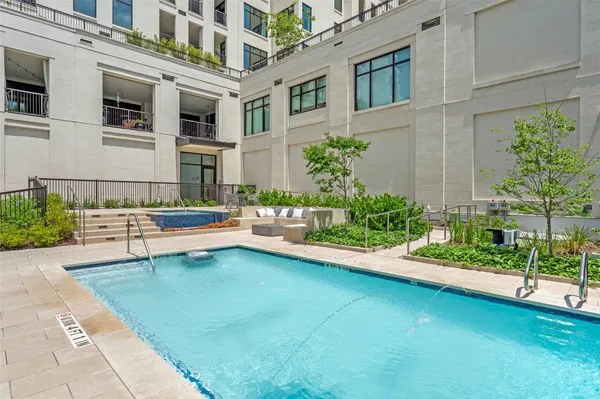 a view of a house with a swimming pool and sitting area