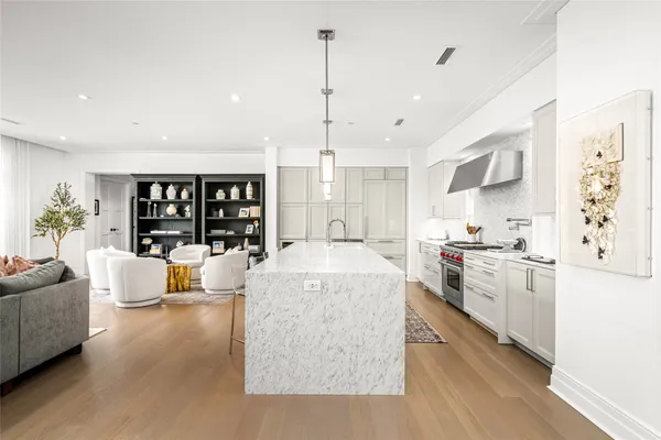 a large white kitchen with a large window