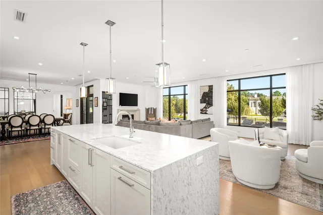 a dining room with furniture wooden floor a rug and a chandelier
