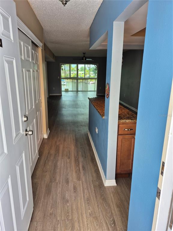 4939 Floramar Terrace, Unit 203 New Port Richey, FL 34652 - Photo 3 of 16 a view of hallway with wooden floor and floor to ceiling window