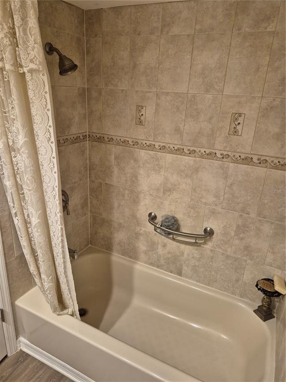 4939 Floramar Terrace, Unit 203 New Port Richey, FL 34652 - Photo 10 of 16 a bathroom with a bathtub