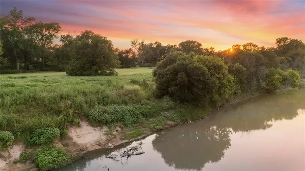 a view of a lake with a forest