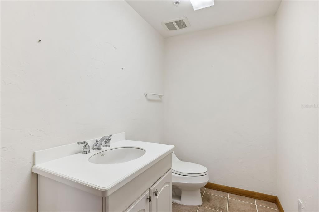 4190 Loomis Avenue Boca Grande, FL 33921 - Photo 15 of 24 a bathroom with a sink a toilet and mirror