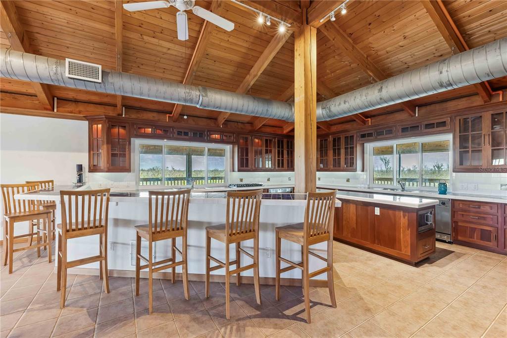 4190 Loomis Avenue Boca Grande, FL 33921 - Photo 5 of 24 a view of a patio with a dining table and chairs with wooden floor