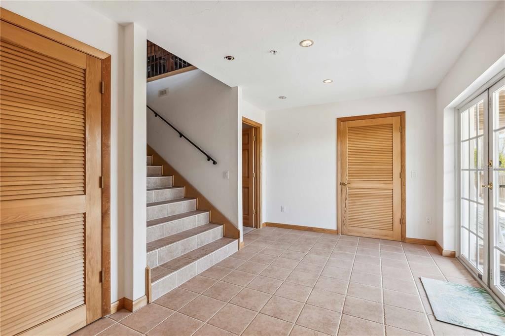 4190 Loomis Avenue Boca Grande, FL 33921 - Photo 7 of 24 a view of entryway with wooden floor and stairs