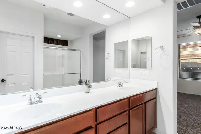 a bathroom with a double vanity sink mirror and double
