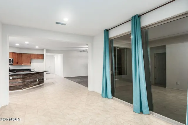 a view of a kitchen with a sink and a refrigerator
