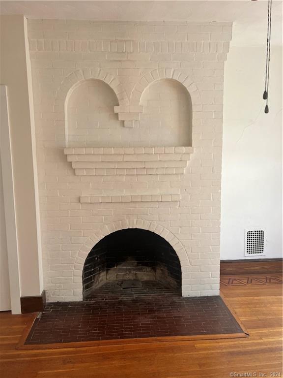 250 Willow Street, Unit 2 New Haven, CT 06511 - Photo 12 of 25 a living room with a fireplace and wooden floor