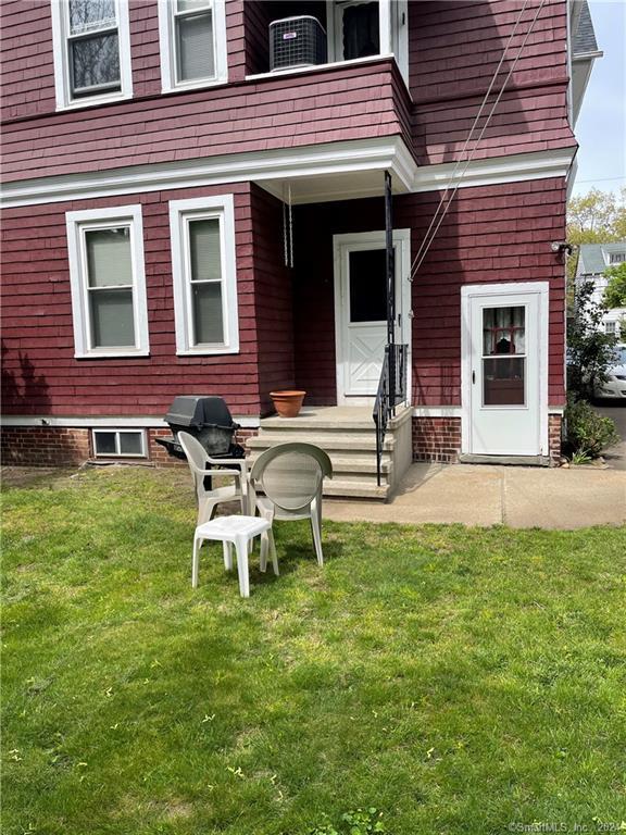 250 Willow Street, Unit 2 New Haven, CT 06511 - Photo 2 of 25 a view of a brick house with a yard chair and table