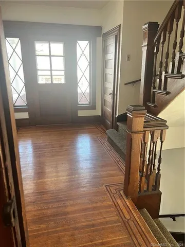a kitchen with granite countertop a refrigerator and a stove top oven