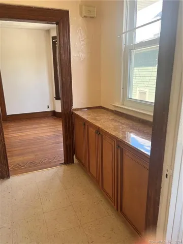a view of a room with wooden floor and a window