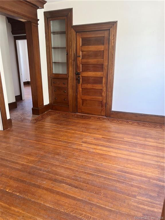 250 Willow Street, Unit 2 New Haven, CT 06511 - Photo 8 of 25 an empty room with wooden floor and closet