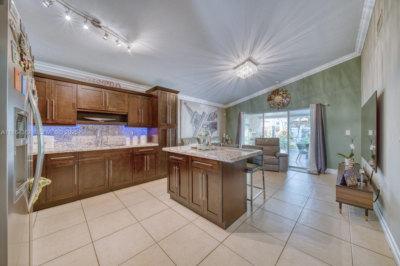 16886 Southwest 143rd Place Miami, FL 33177 - Photo 18 of 39 a kitchen with stainless steel appliances granite countertop a sink and cabinets