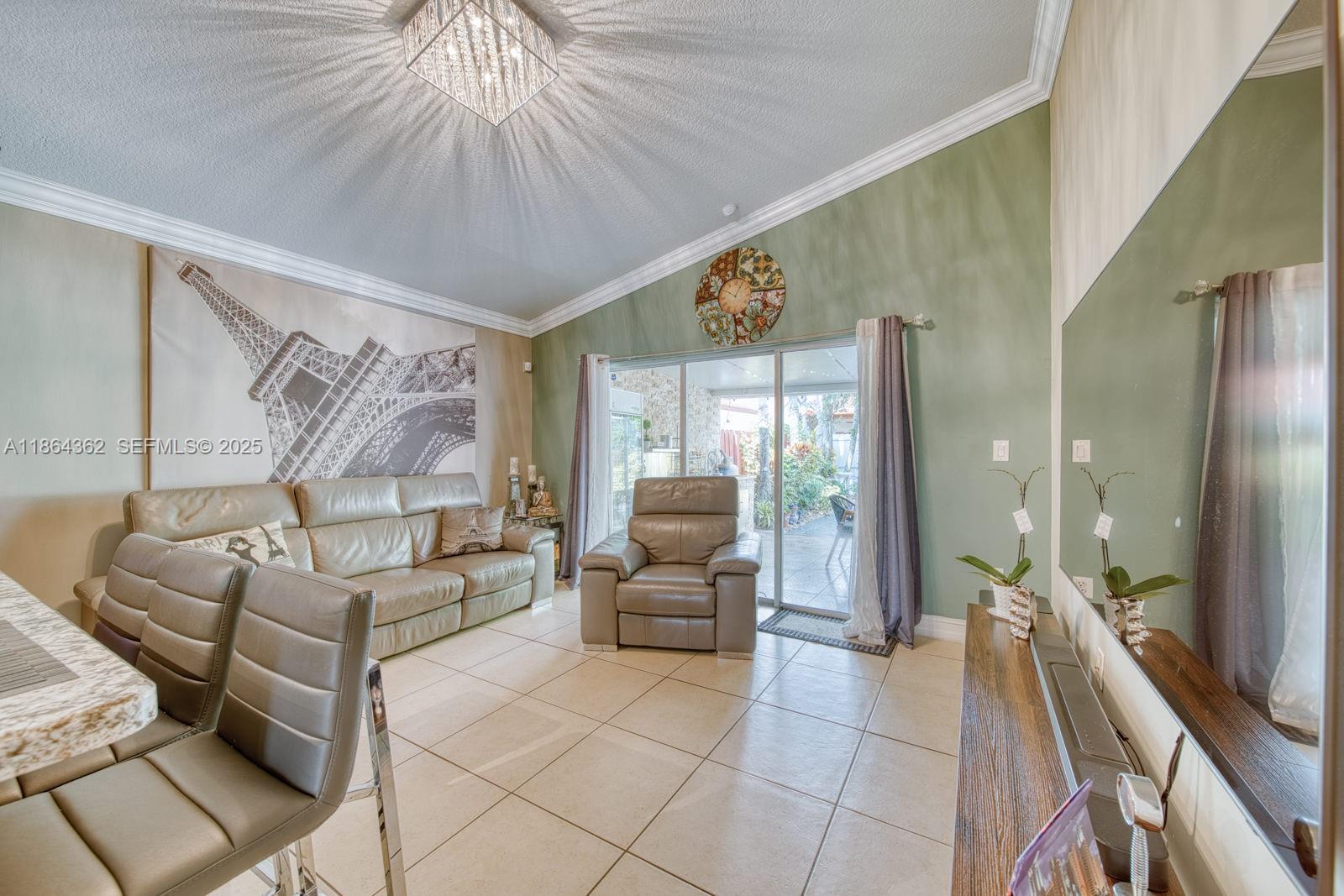 16886 Southwest 143rd Place Miami, FL 33177 - Photo 20 of 39 a living room with furniture and a large window